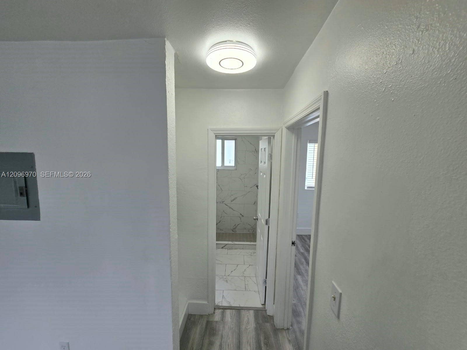 535 NW 7th Street, #12, Miami, Miami, FL 33136 Flush-mount LED ceiling lighting, wood-finish flooring, and a bathroom featuring large-format tile flooring and wall surfacing