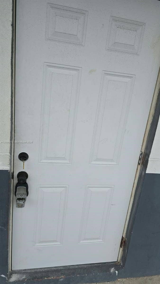 535 NW 7th Street, #12, Miami, Miami, FL 33136 Six-panel white door with dual deadbolt and keyless entry hardware