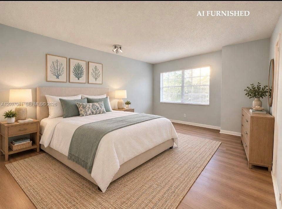 3271 Coral Springs Drive, #2, Coral Springs, Coral Springs, FL 33065 Neutral-toned wall paint, wood-finish flooring, and a multi-pane window with natural light exposure