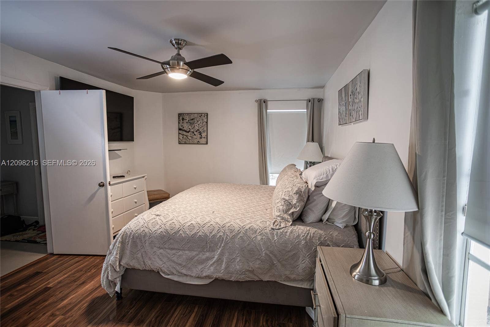 A calm, light filled retreat with a ceiling fan.