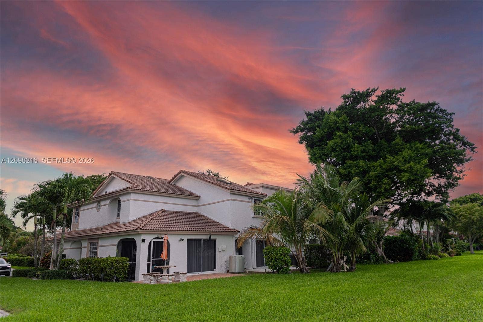 The home at sunset, set on manicured grounds.