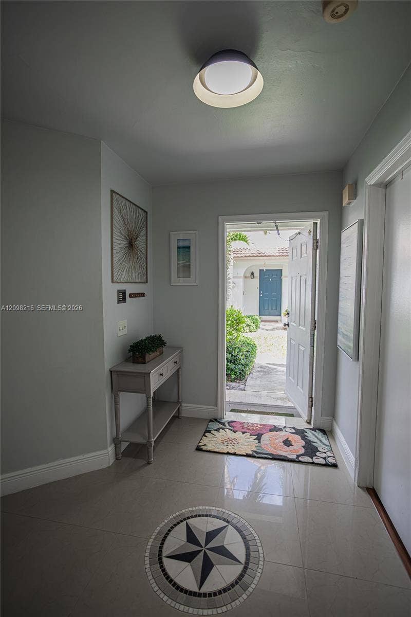 Bright entry hall with tile floors and natural light leading into the main living space.