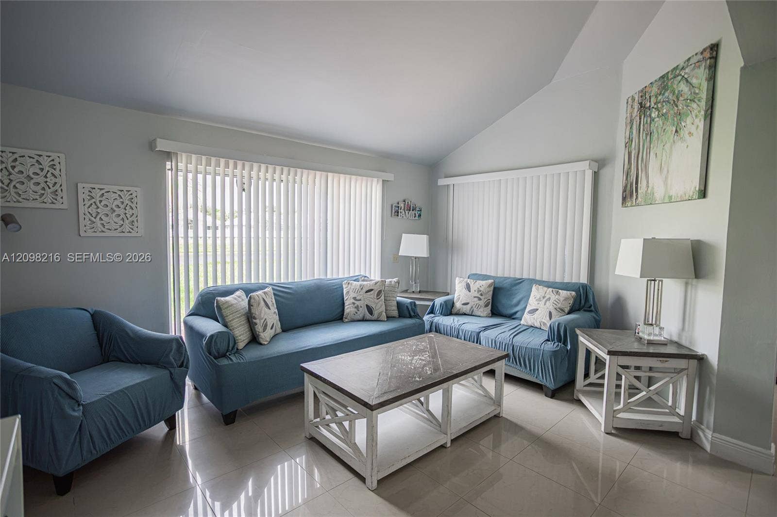 Spacious living room with high ceilings and generous room for seating.