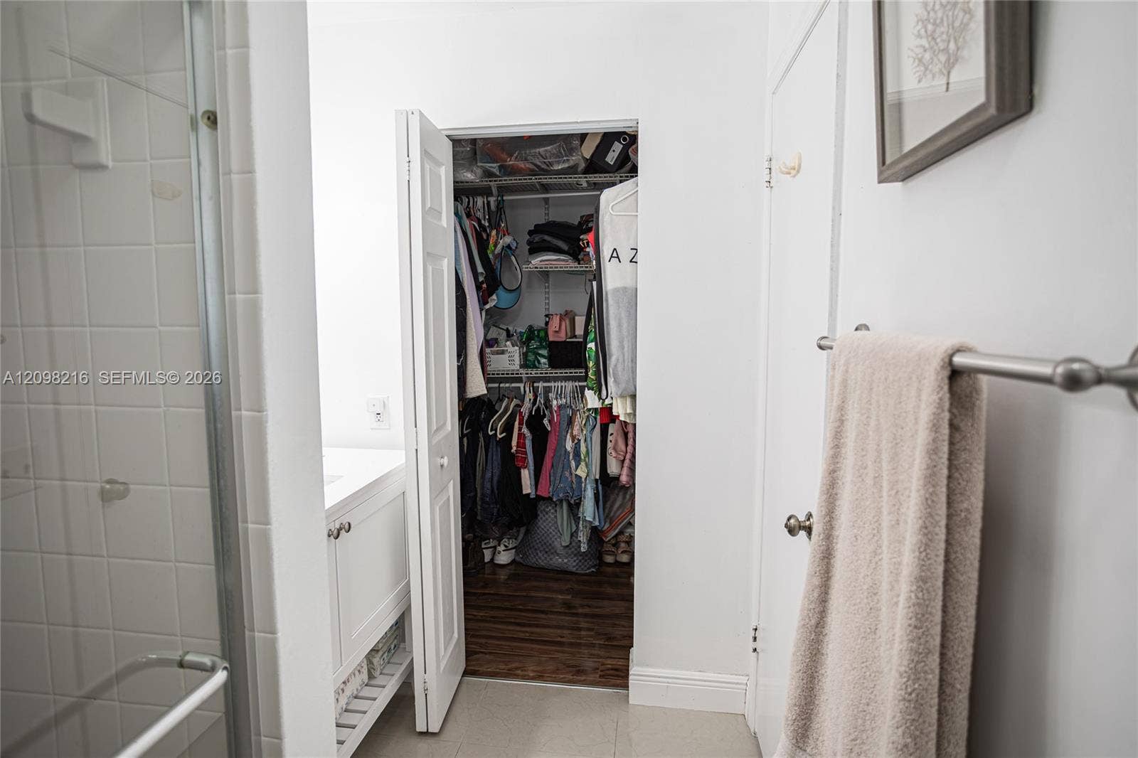 Bathroom with direct access to a walk-in closet.