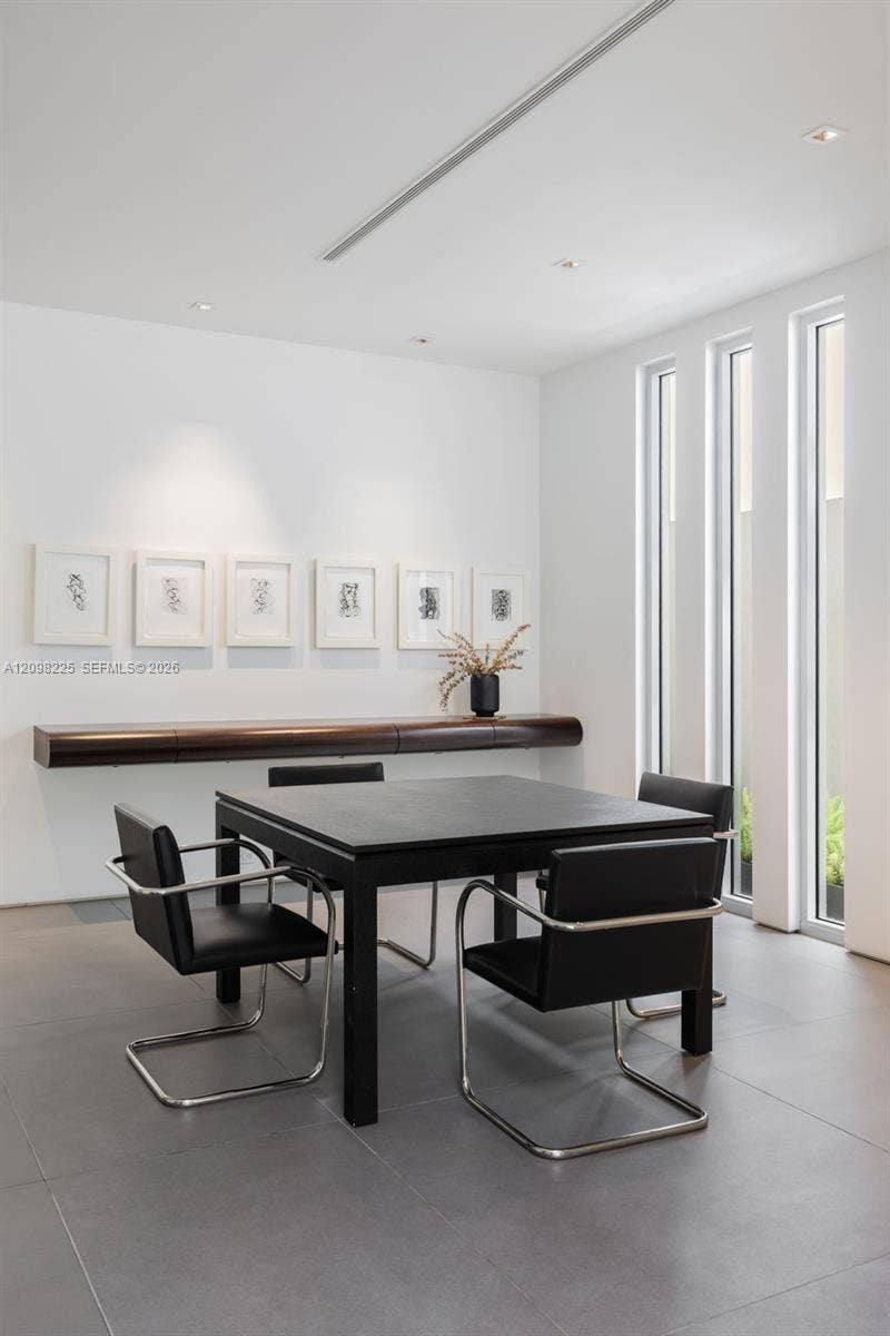Wall-mounted custom wood shelving, large-format tile flooring, recessed ceiling lighting, and floor-to-ceiling vertical windows