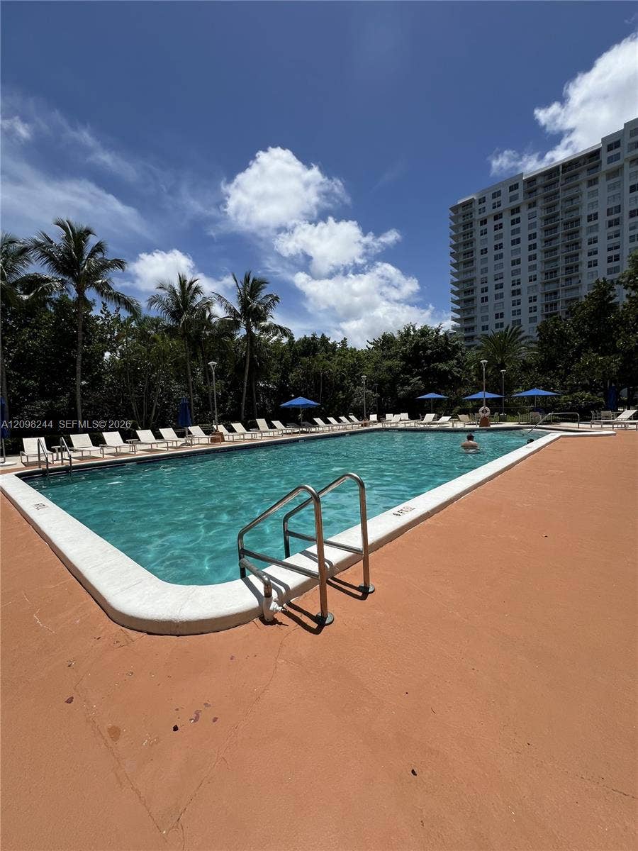 2851 NE 183rd Street, #2110E, Aventura, Aventura, FL 33160 Rectangular swimming pool with integrated metal handrails, white coping, and surrounding concrete deck
