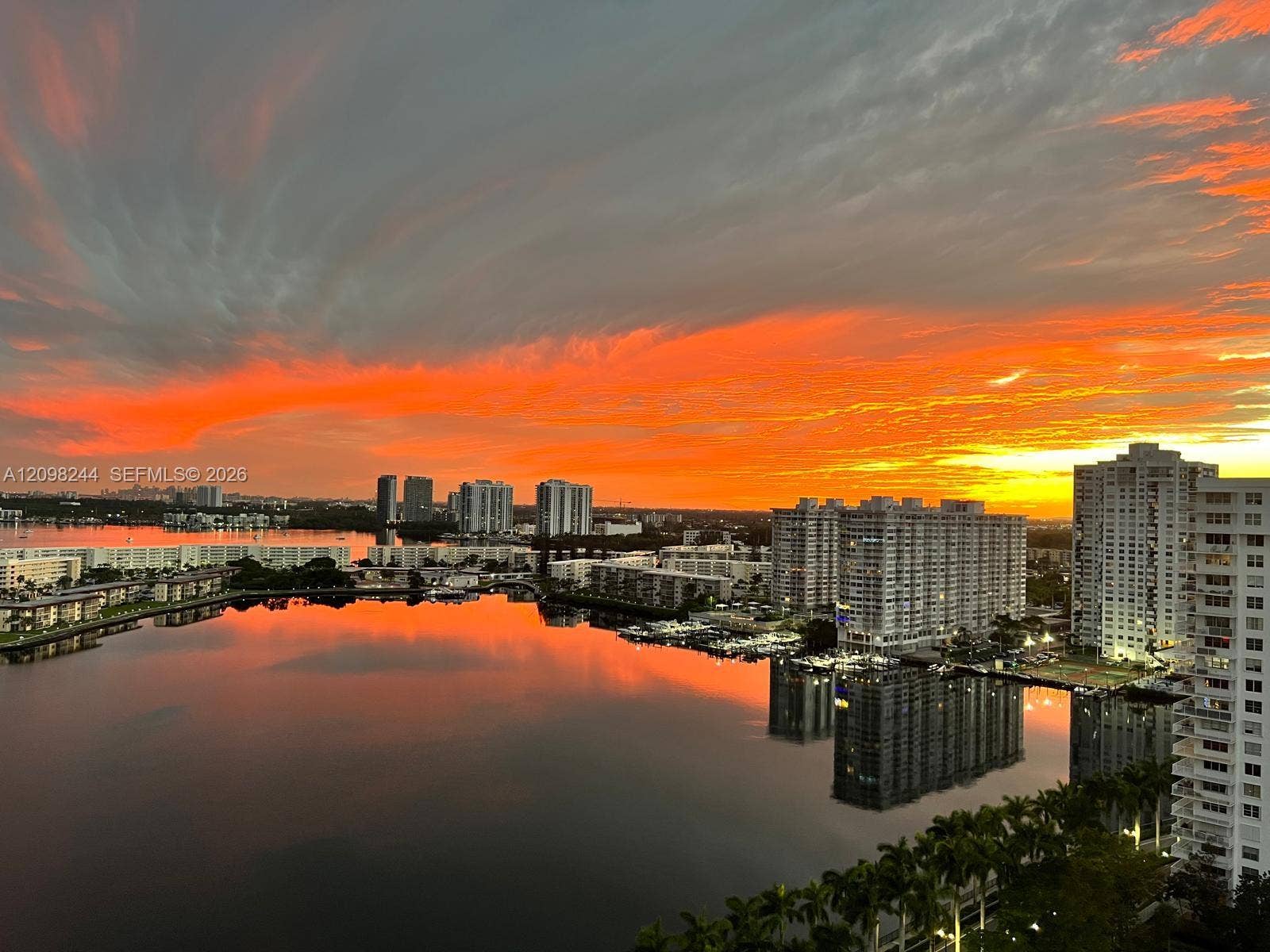 2851 NE 183rd Street, #2110E, Aventura, Aventura, FL 33160 High-rise perspective featuring a sunset backdrop over an expansive waterway and metropolitan skyline