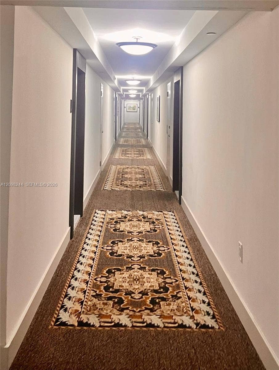 2851 NE 183rd Street, #2110E, Aventura, Aventura, FL 33160 Hallway featuring recessed ceiling lighting, wall-mounted flush-mount light fixtures, and patterned carpet flooring