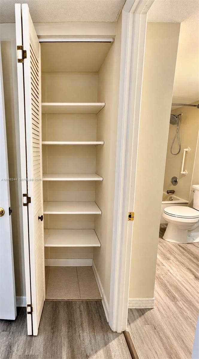 2851 NE 183rd Street, #2110E, Aventura, Aventura, FL 33160 Built-in storage closet with louvered bi-fold doors and five fixed shelves