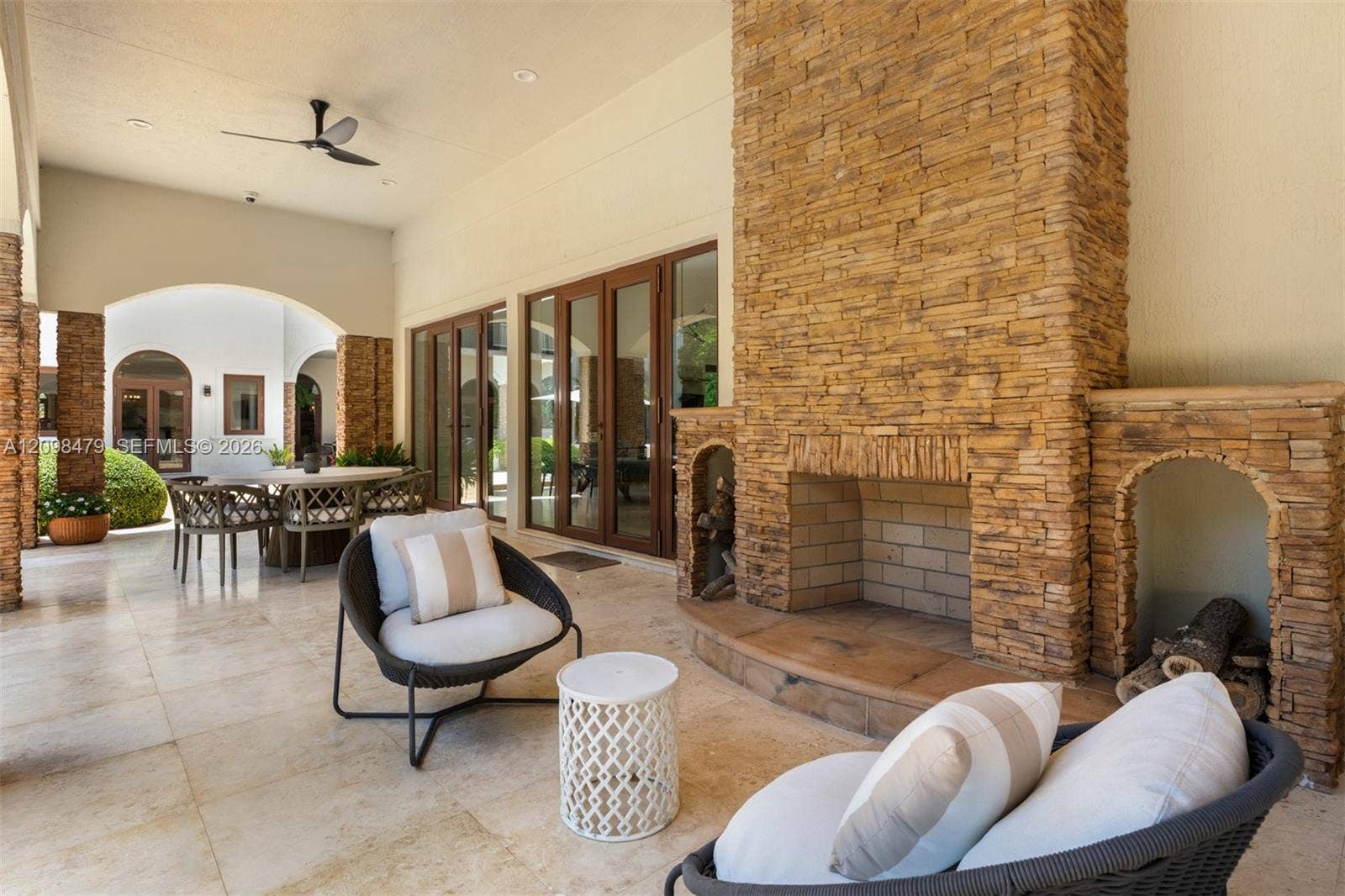 Stone-clad outdoor fireplace with integrated wood storage