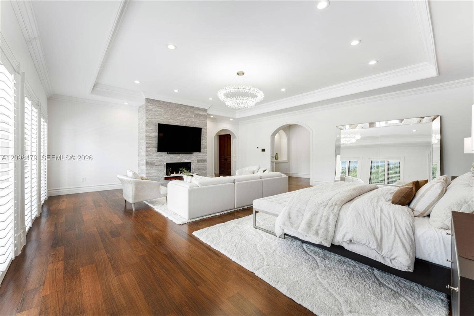 Wood-finish flooring, recessed lighting, and crown molding