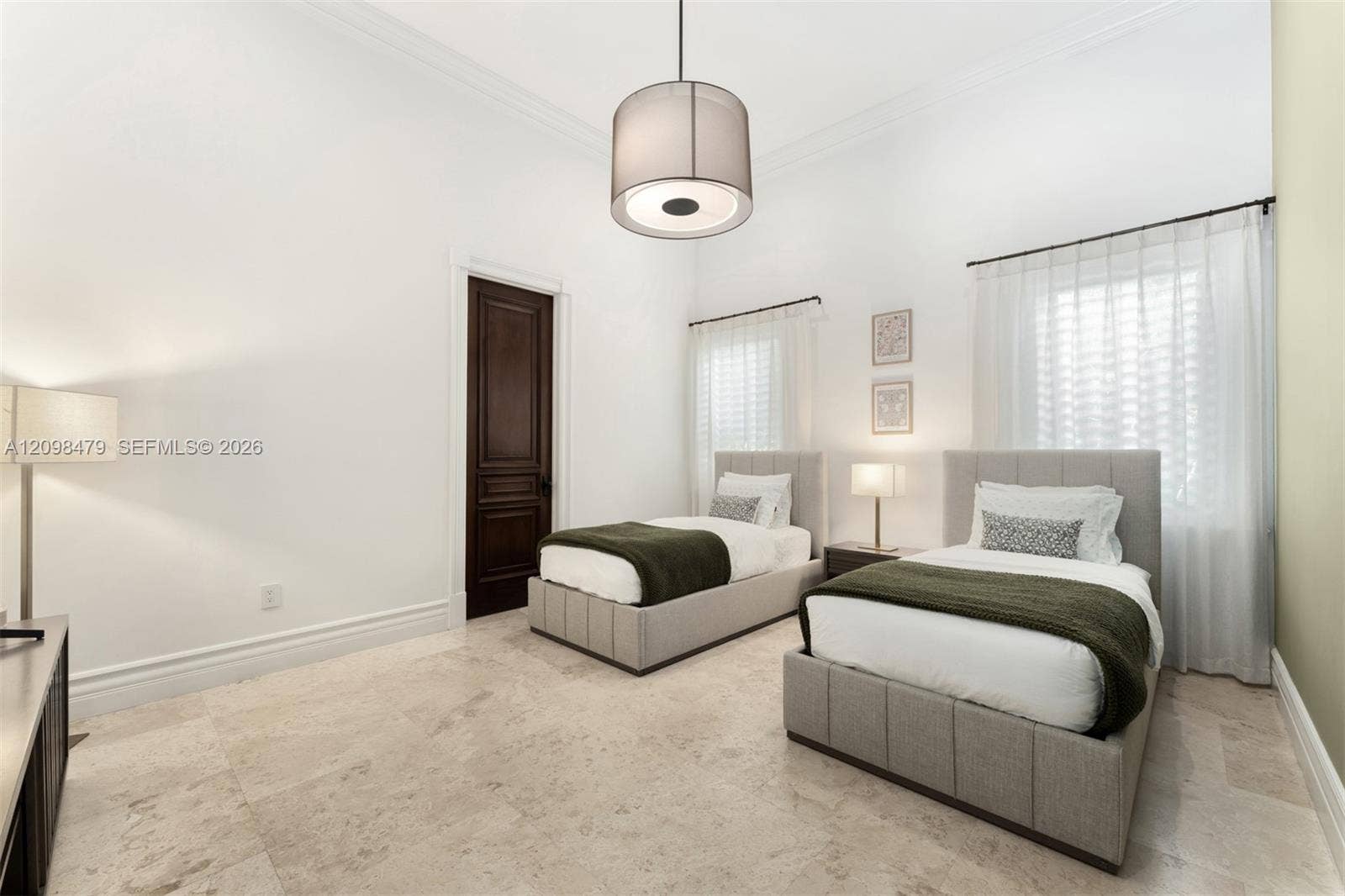 Recessed lighting and a drum pendant fixture illuminate the space