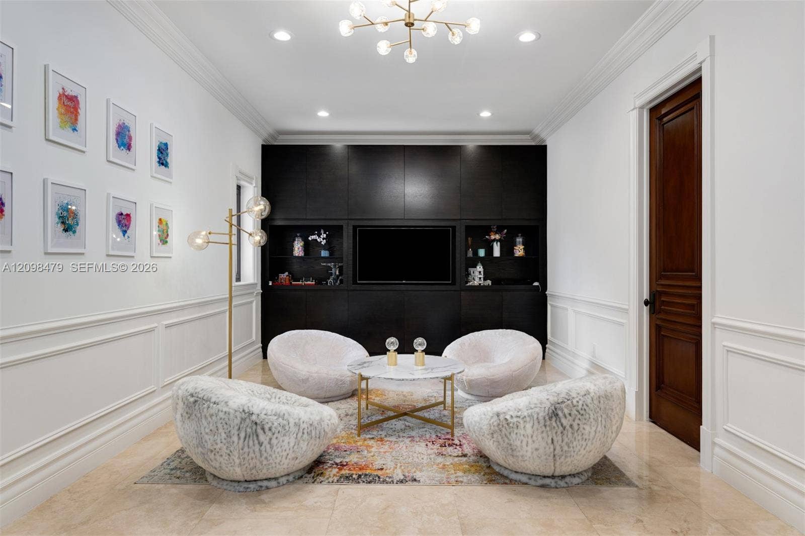Recessed lighting with a modern chandelier, dark wood-finish built-in cabinetry, elegant wainscoting, and large format tile flooring