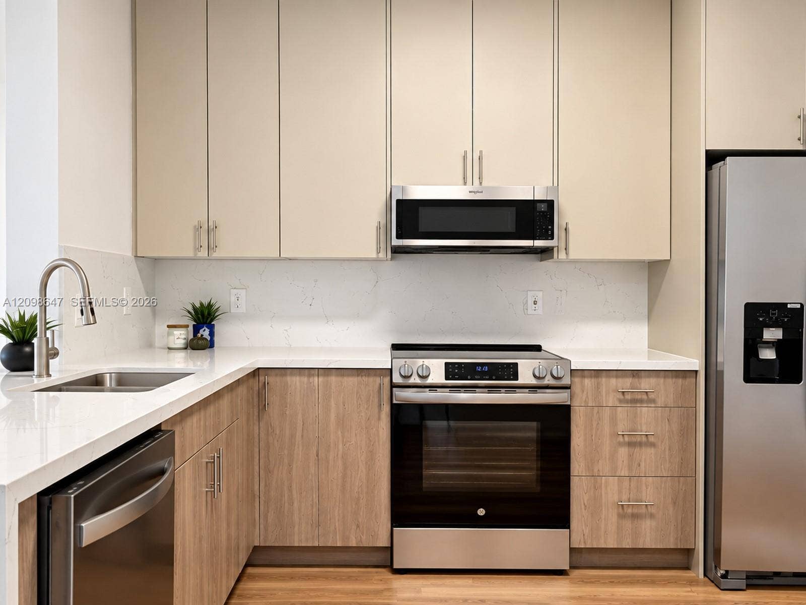 3818 San Simeon Circle, #3818, Weston, Weston, FL 33331 Modern kitchen layout with elegant Carrara quartz surfaces, matching tile backsplash, and generous cabinet storage space.