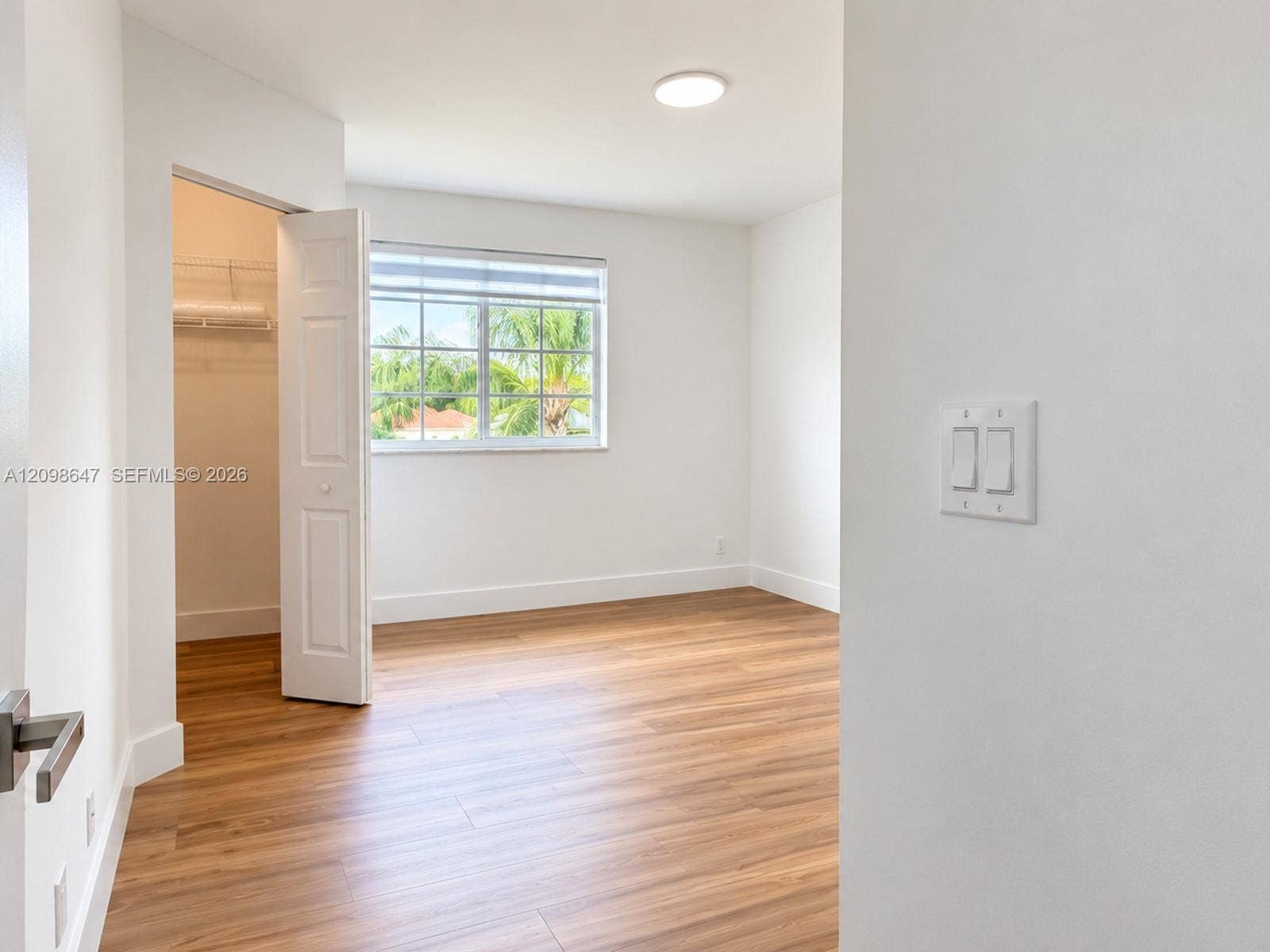 3818 San Simeon Circle, #3818, Weston, Weston, FL 33331 Spacious bedroom with warm wood-look floors, abundant natural light, and clean finishes.