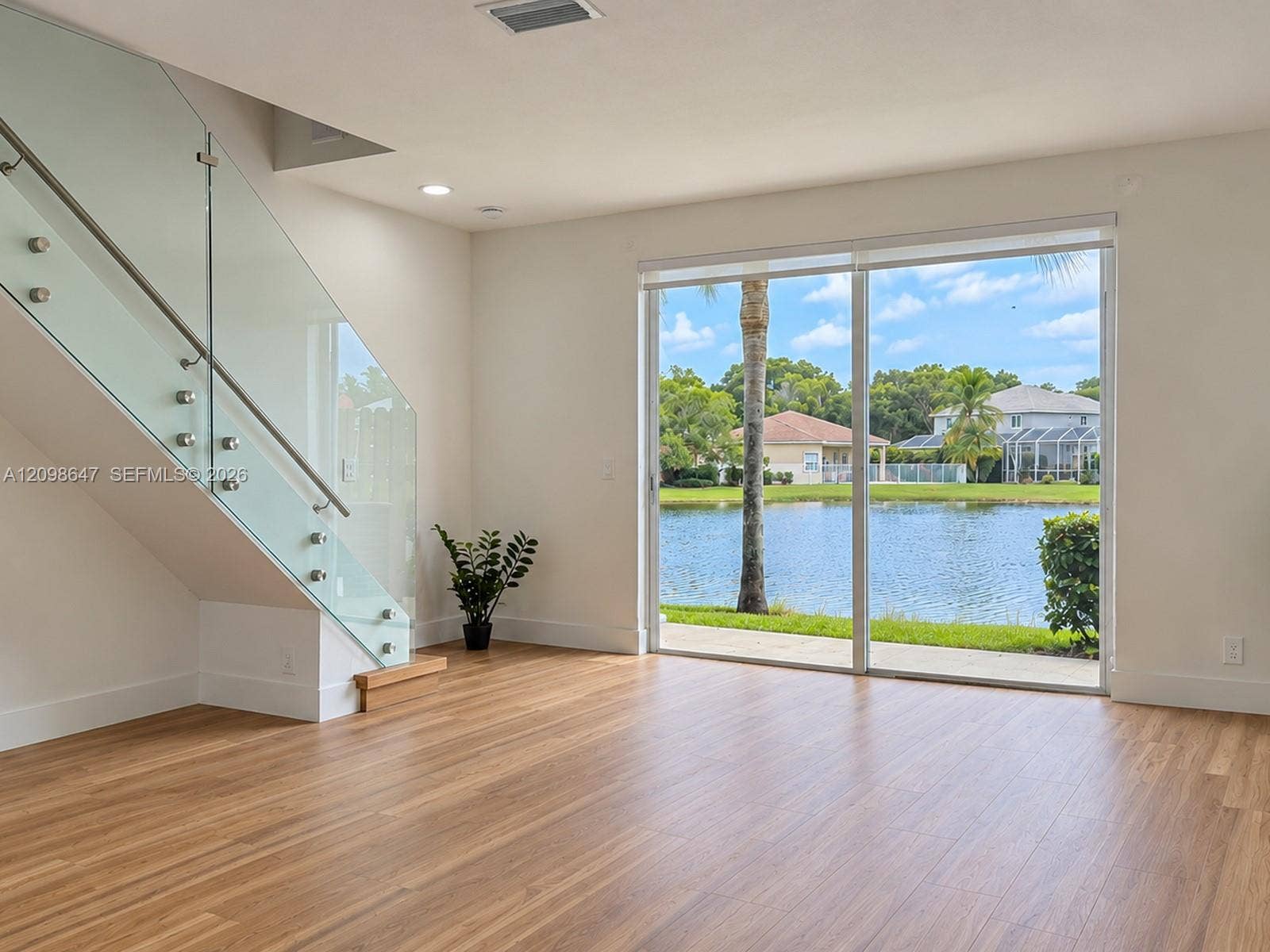 3818 San Simeon Circle, #3818, Weston, Weston, FL 33331 Light-filled living room with large glass doors offering direct scenic views of t