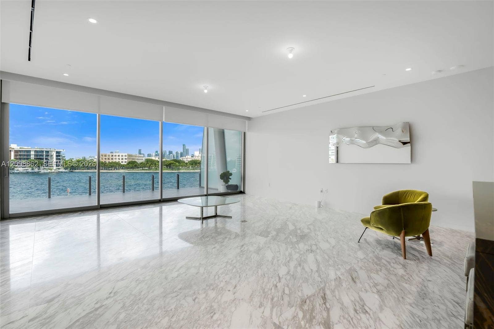 Floor-to-ceiling glass windows, polished stone flooring, recessed ceiling lighting, and minimalist wall surfaces