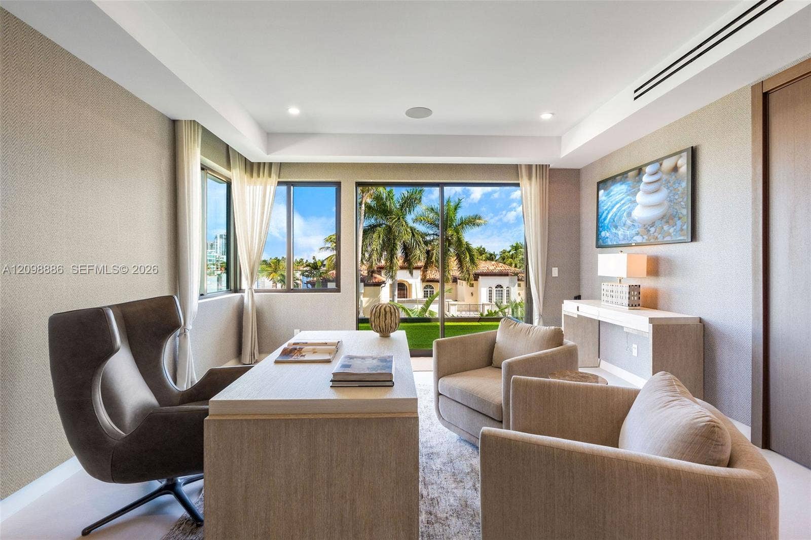 Room featuring textured wallpaper, recessed lighting, crown molding, built-in recessed wall shelving, and floor-to-ceiling glass doors with outdoor scenery