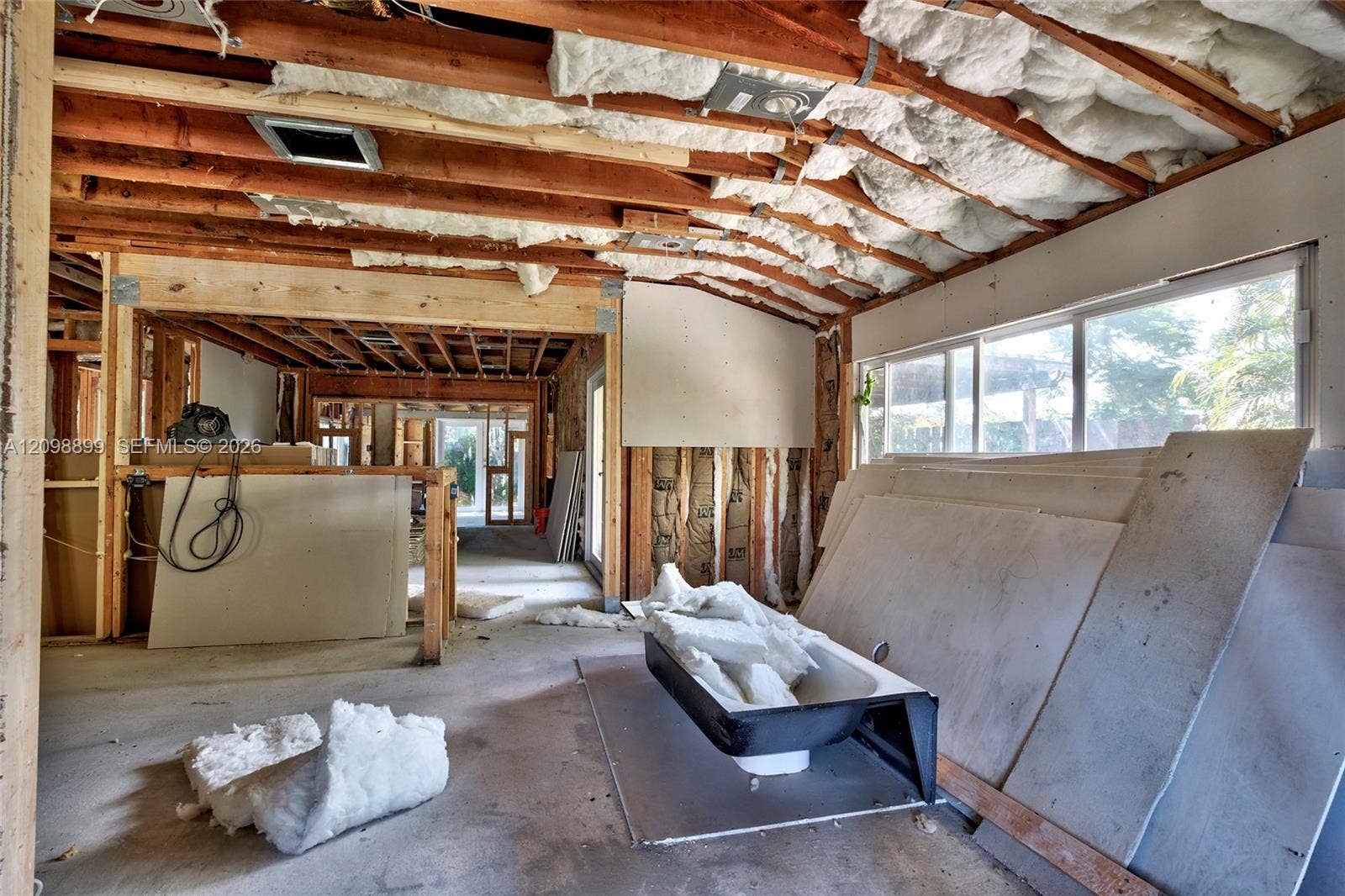 1176 SW 4th Street, Boca Raton, FL 33486 Exposed wood beam construction featuring fiberglass batt insulation, concrete flooring, and horizontal sliding windows