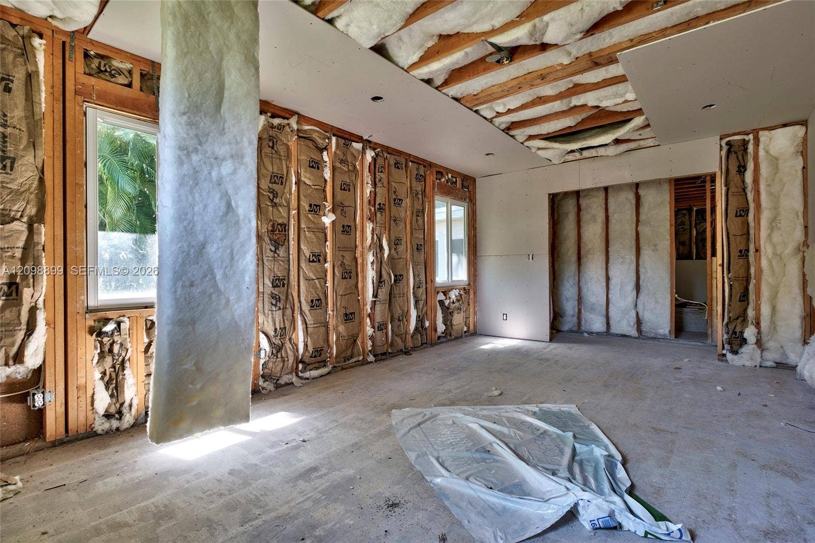 1176 SW 4th Street, Boca Raton, FL 33486 Interior space featuring exposed wood framing, installed batt insulation, and dual-pane windows