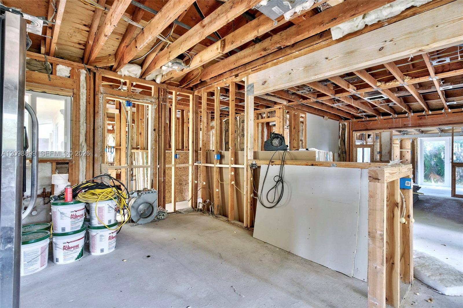 1176 SW 4th Street, Boca Raton, FL 33486 Open-concept structural interior featuring exposed timber framing, concrete flooring, and multiple window openings