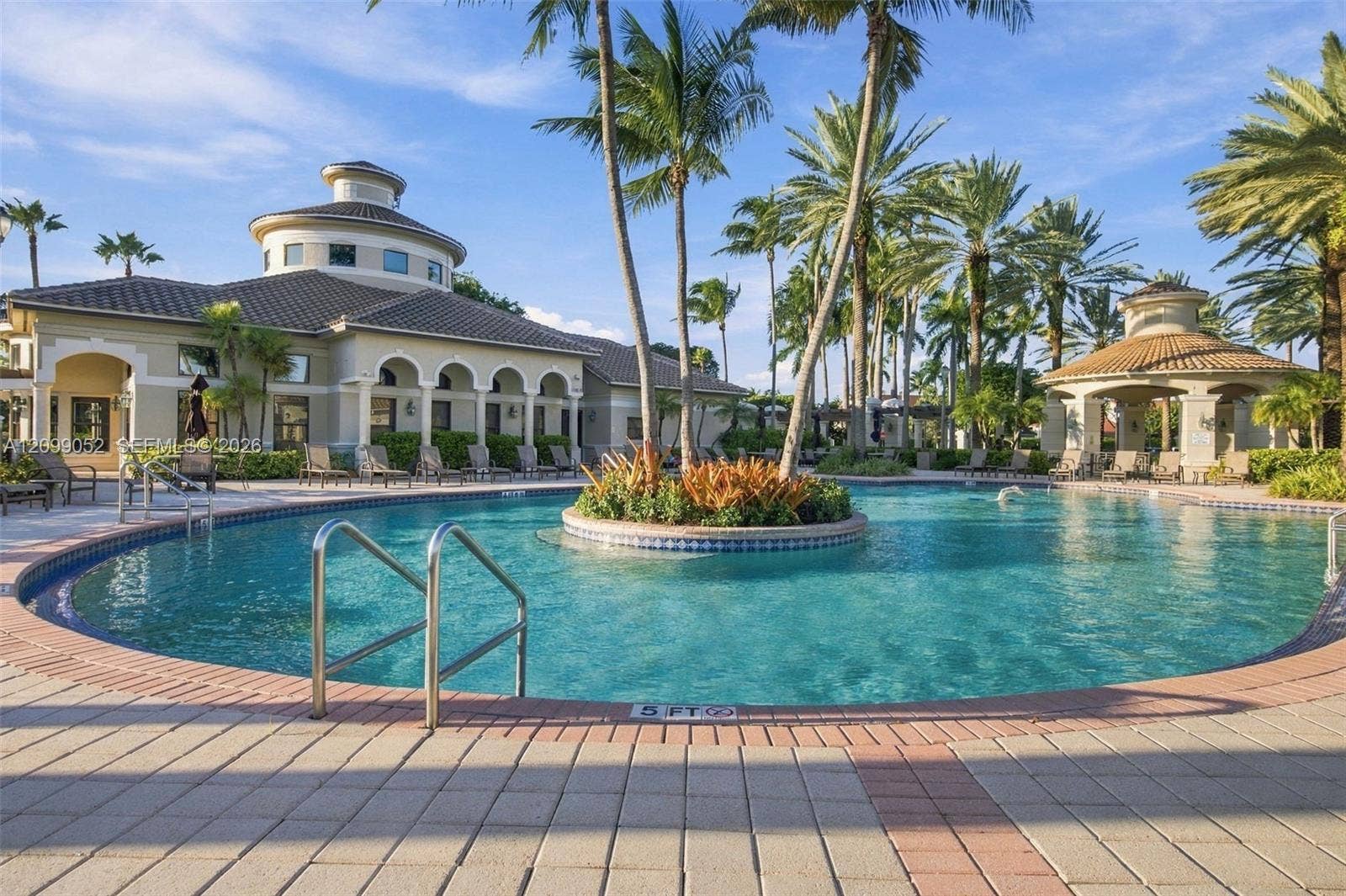 1516 Breakwater Terrace, Hollywood, FL 33019 Community pool featuring a central island planter, stone paver decking, covered gazebo, and arched architectural detailing