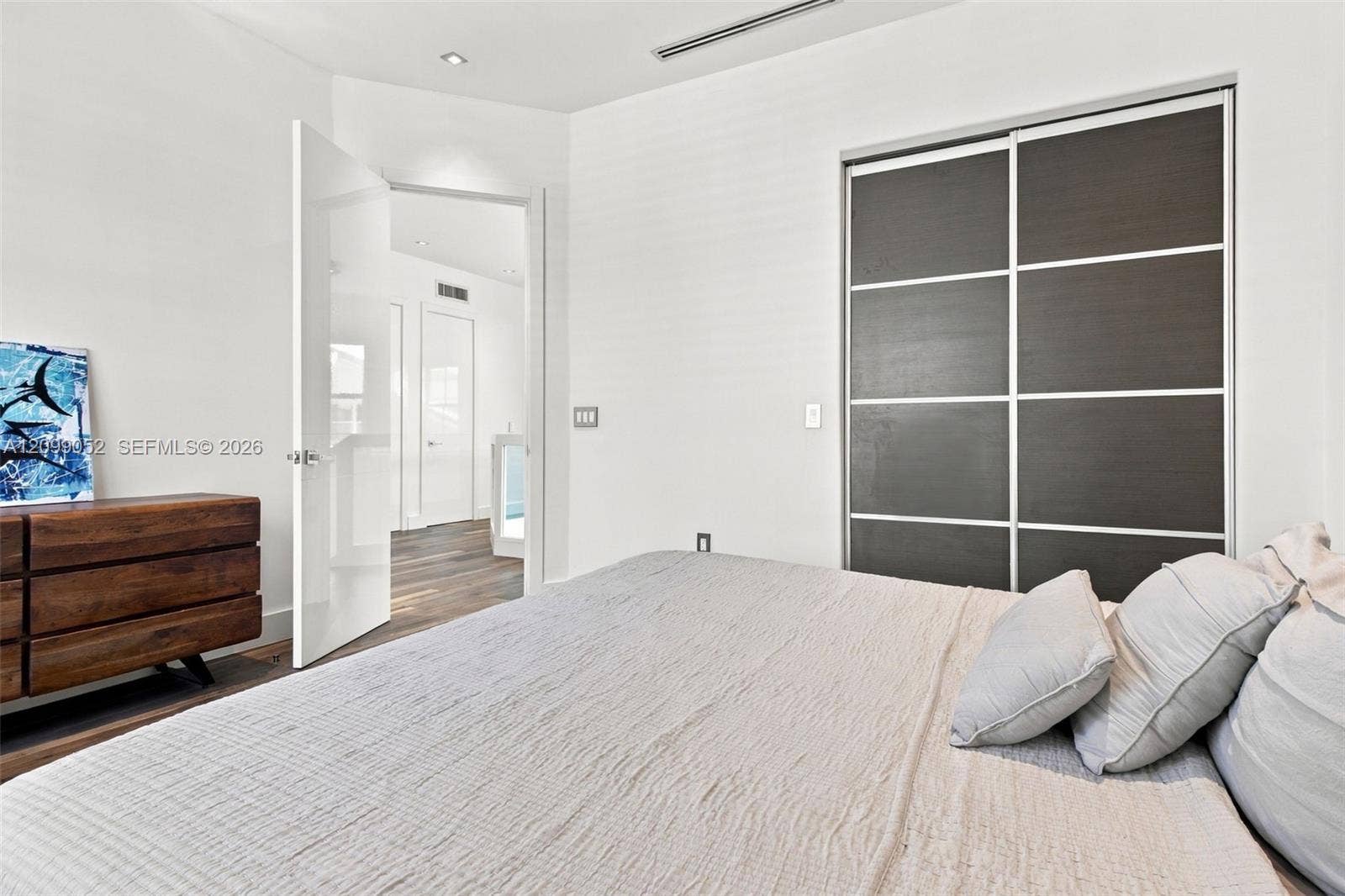 1516 Breakwater Terrace, Hollywood, FL 33019 Sliding closet doors with dark wood-finish panels, recessed ceiling lighting, and crisp white walls