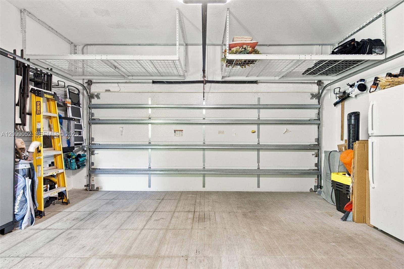 1516 Breakwater Terrace, Hollywood, FL 33019 Garage featuring overhead metal storage racks and concrete flooring