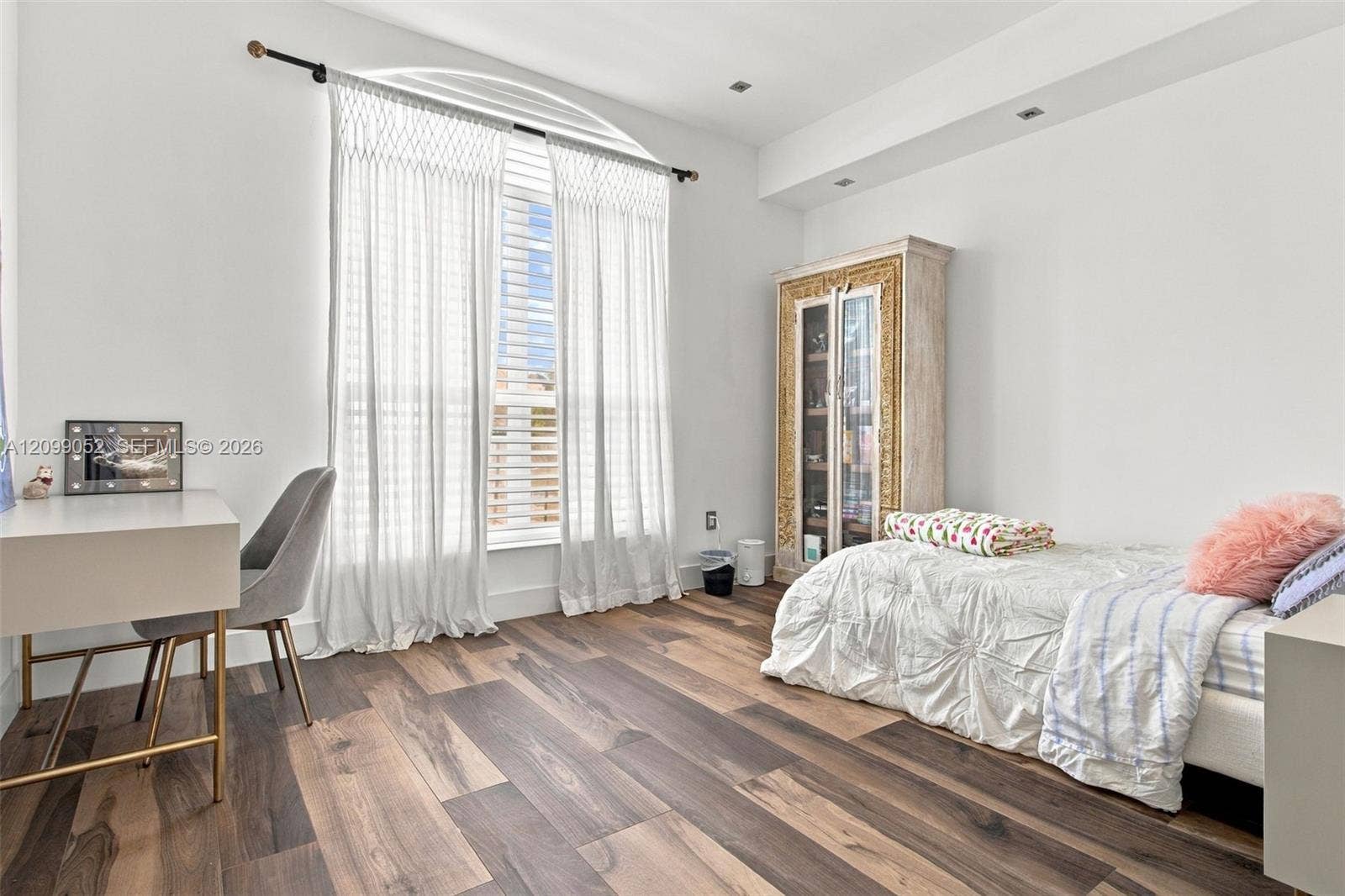 1516 Breakwater Terrace, Hollywood, FL 33019 Arched window featuring floor-to-ceiling drapery and wood-finish flooring with recessed ceiling lighting