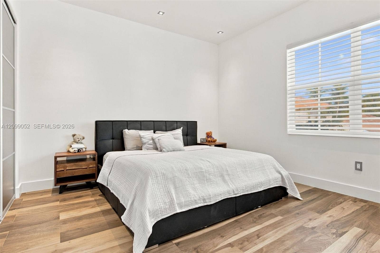 1516 Breakwater Terrace, Hollywood, FL 33019 Bedroom featuring wood-finish flooring, recessed lighting, and a window with horizontal blinds