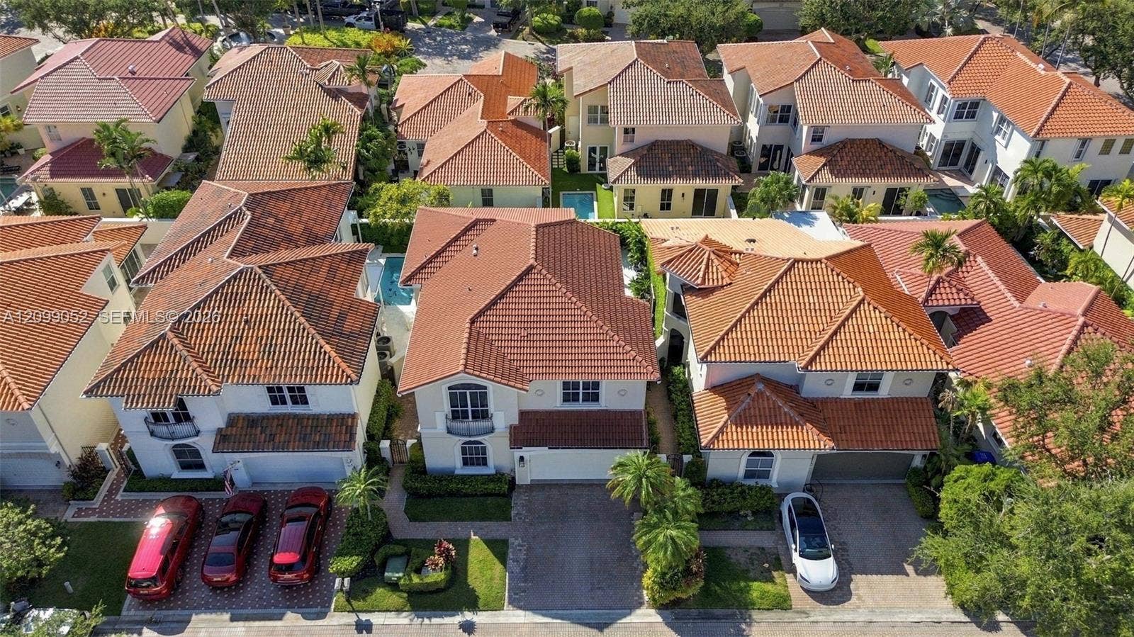 1516 Breakwater Terrace, Hollywood, FL 33019 Aerial perspective of a multi-story residence featuring a terracotta-style tile roof, stucco exterior, integrated garage, and private pool