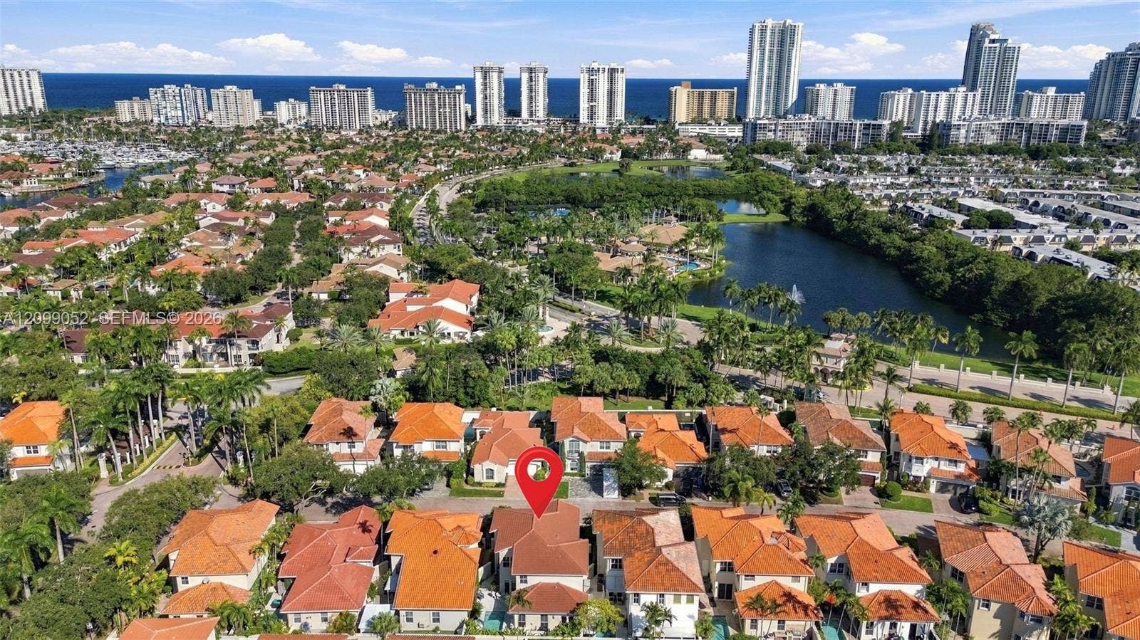 1516 Breakwater Terrace, Hollywood, FL 33019 Aerial perspective of residential community featuring tiled roofs, manicured landscaping, integrated water features, and proximity to the coastline