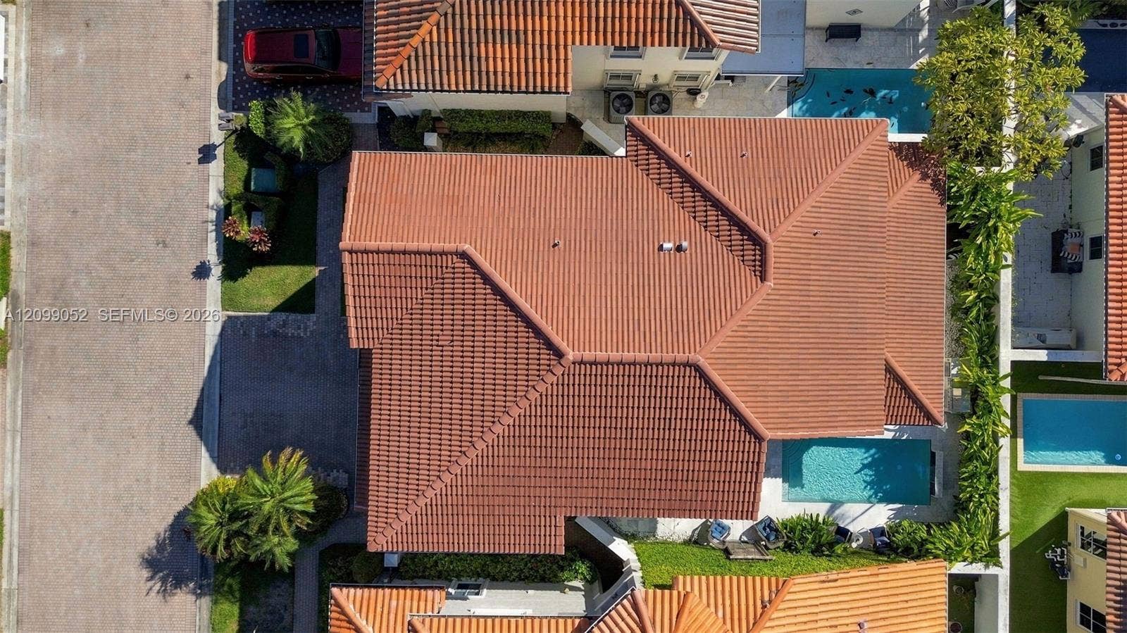 1516 Breakwater Terrace, Hollywood, FL 33019 Aerial perspective featuring a tile roof, private swimming pool, and landscaping
