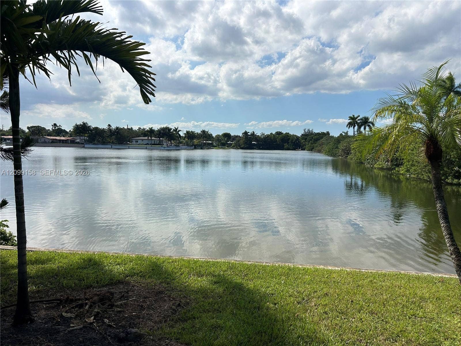 1490 Lenape Drive, Miami Springs, FL 33166 Large-format sliding glass doors, ceramic tile flooring, neutral wall palette, and recessed lighting
