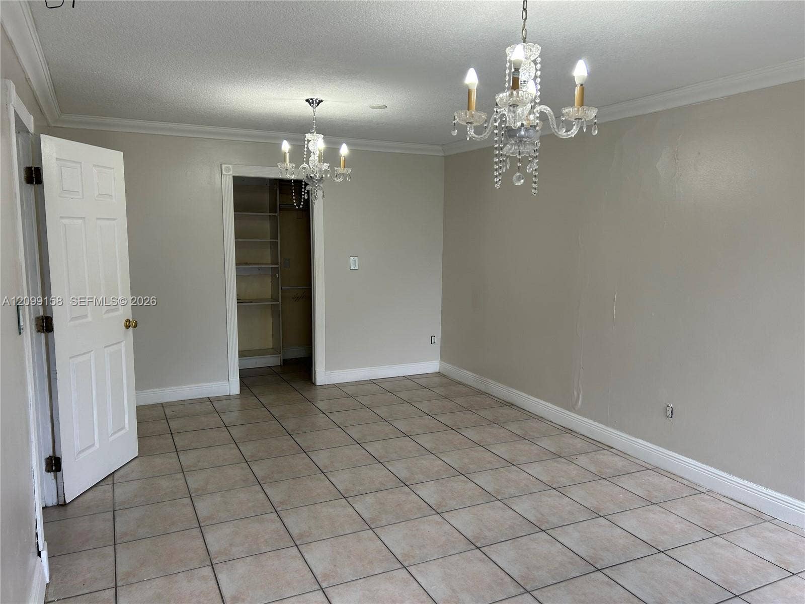 1490 Lenape Drive, Miami Springs, FL 33166 Bathroom featuring square stone tile wall and floor surfaces, vessel sink with chrome faucet, dark wood-finish vanity, and walk-in shower with rain showerhead