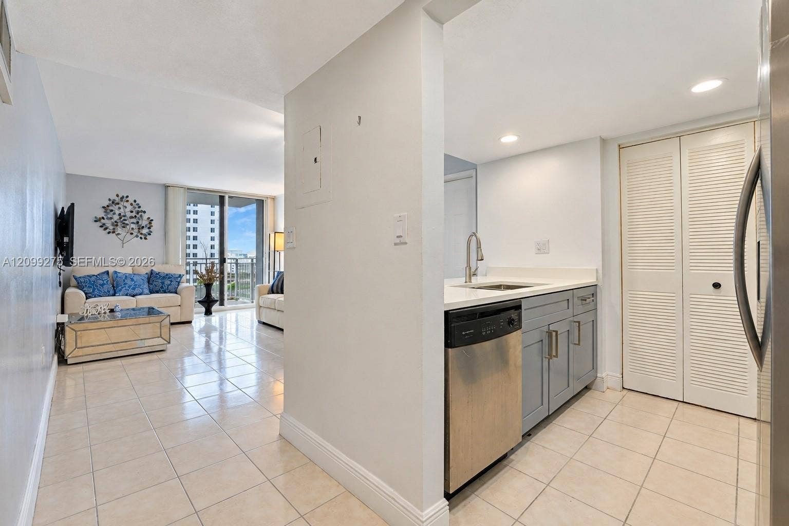 800 N Miami Avenue, #E-902, Miami, Miami, FL 33136 Modern galley kitchen featuring gray cabinetry, white countertops, stainless steel appliances, a double-basin sink, and tile flooring.