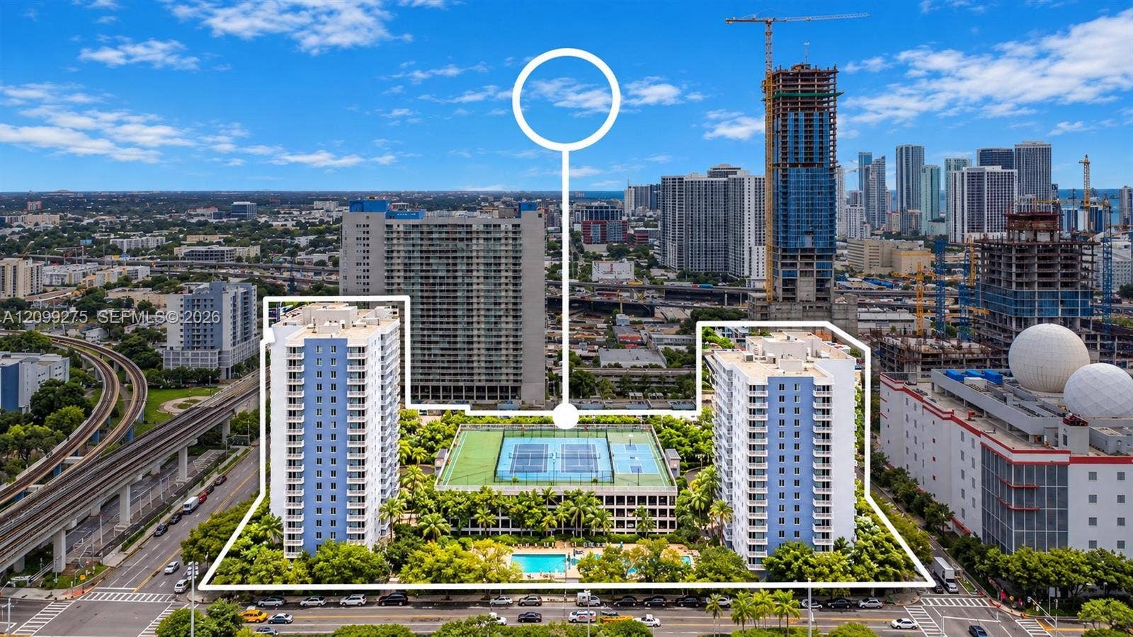 800 N Miami Avenue, #E-902, Miami, Miami, FL 33136 Aerial view highlighting the condominium complex, featuring two residential towers, sports court, a swimming pool, and lush landscaped grounds, set against the vibrant Miami downtown skyline. The white outline emphasizes the property boundaries and its amenities.