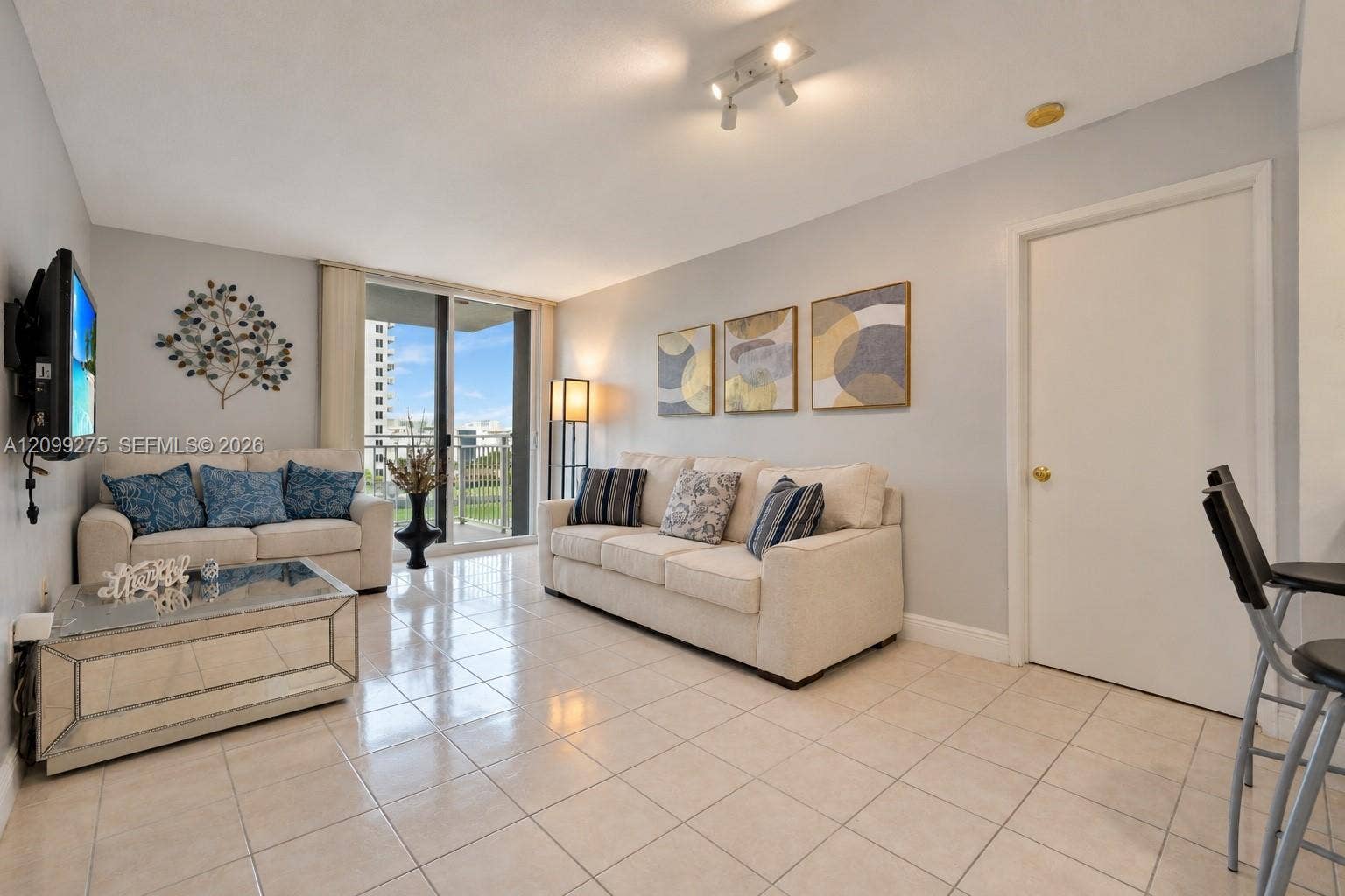 800 N Miami Avenue, #E-902, Miami, Miami, FL 33136 Bright, inviting living room with tile flooring and sliding glass doors opening to a private balcony.