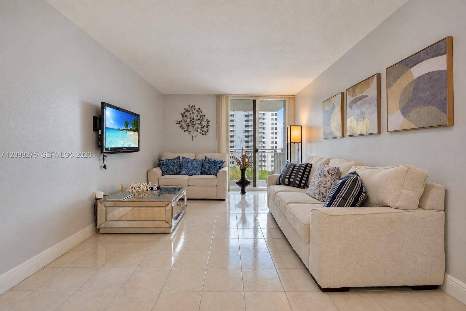 800 N Miami Avenue, #E-902, Miami, Miami, FL 33136 Bright and inviting living room featuring neutral tones, and sliding glass doors opening to a private balcony.