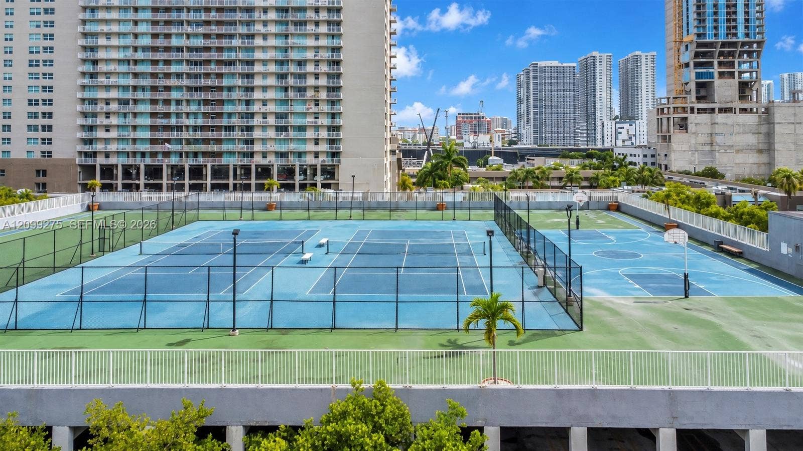 800 N Miami Avenue, #E-902, Miami, Miami, FL 33136 Recreational amenities featuring tennis courts, basketball courts, and panoramic views of Miamis high-rise skyline.
