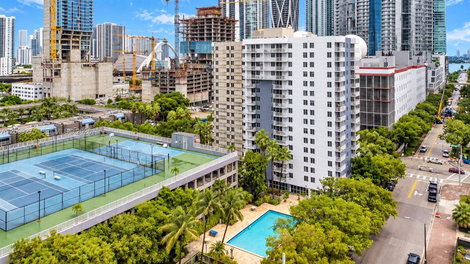 800 N Miami Avenue, #E-902, Miami, Miami, FL 33136 Enjoy resort-style amenities including a swimming pool and sports courts, surrounded by lush tropical landscaping and a vibrant urban skyline.