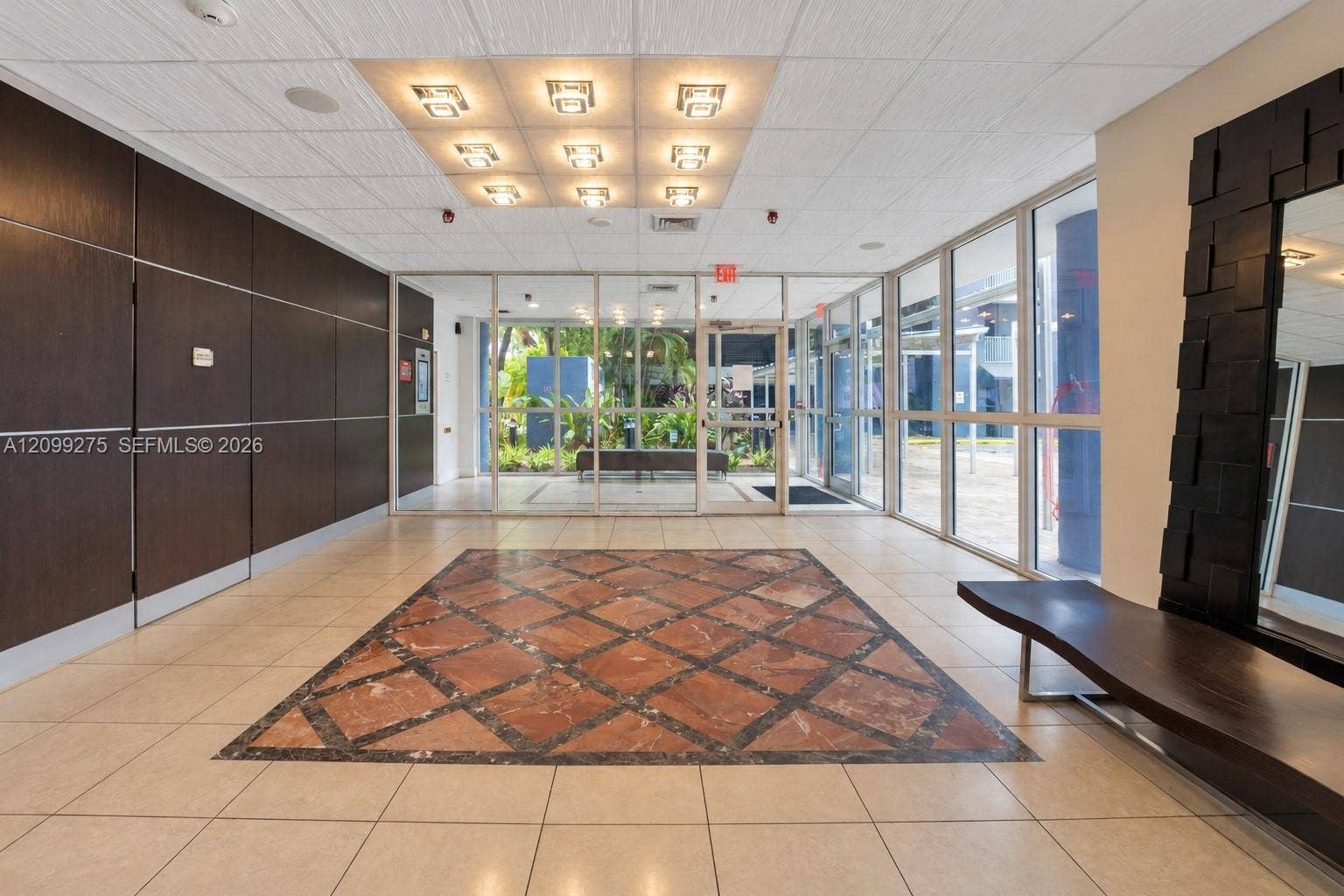 800 N Miami Avenue, #E-902, Miami, Miami, FL 33136 Elegant building lobby featuring decorative marble flooring, modern lighting, glass entry doors, and a welcoming reception-style seating area.