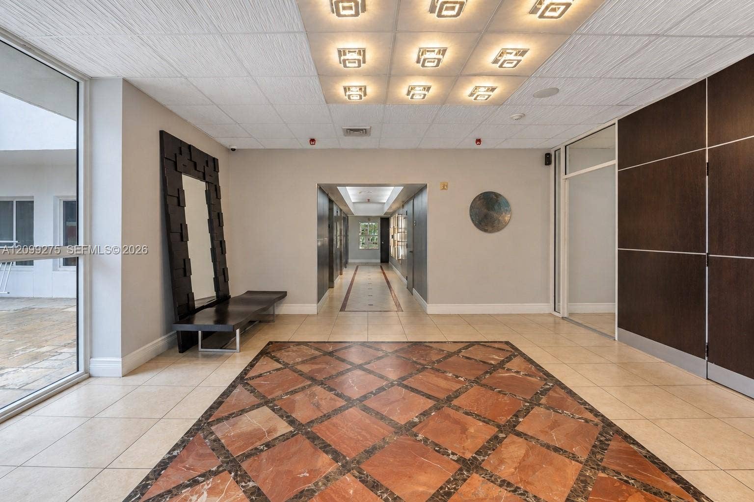 800 N Miami Avenue, #E-902, Miami, Miami, FL 33136 Bright and spacious building entrance foyer featuring elegant tile flooring, comfortable seating, and secure entrance.