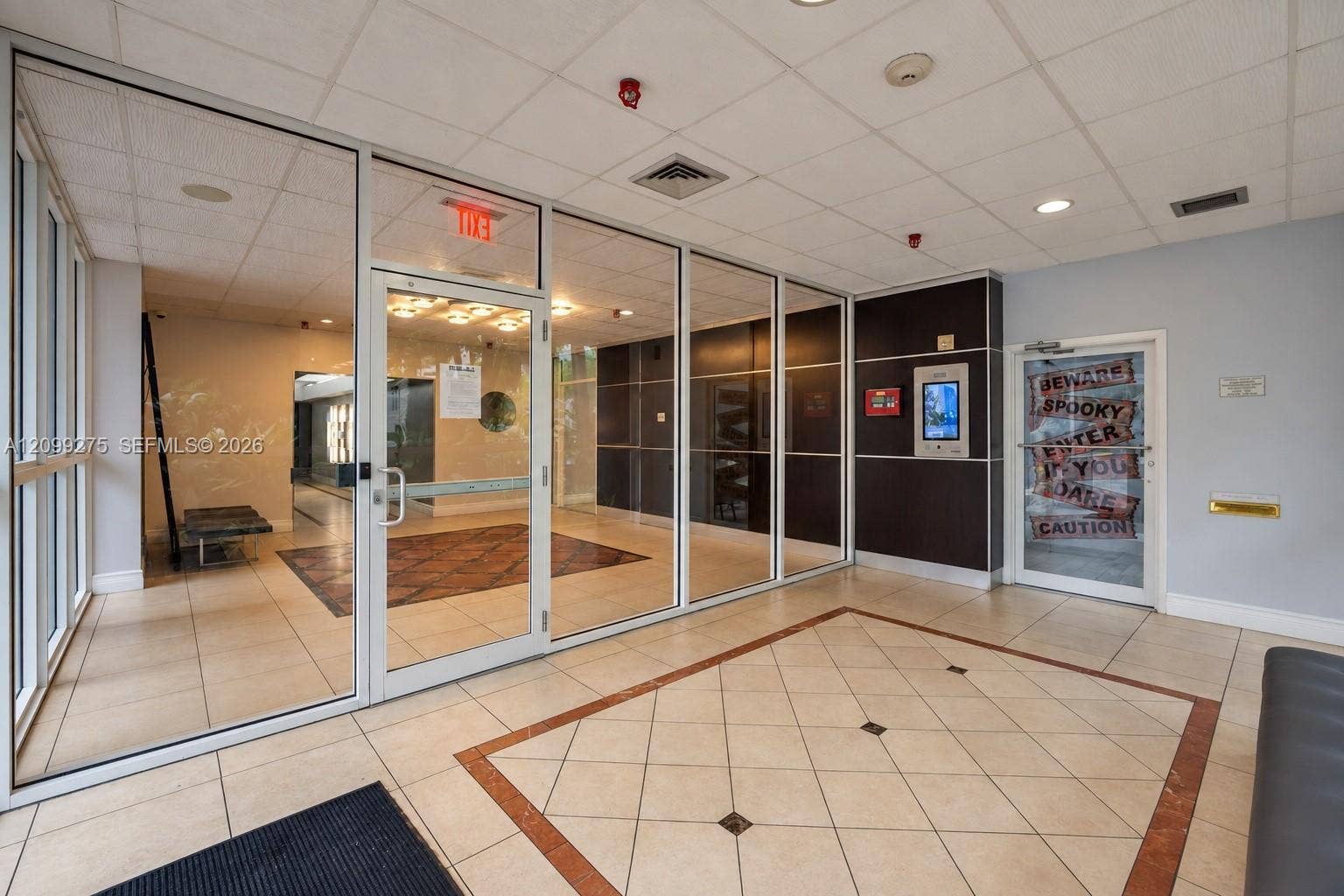 800 N Miami Avenue, #E-902, Miami, Miami, FL 33136 Secure building entrance featuring glass doors, a spacious tiled foyer, and a modern access control system.