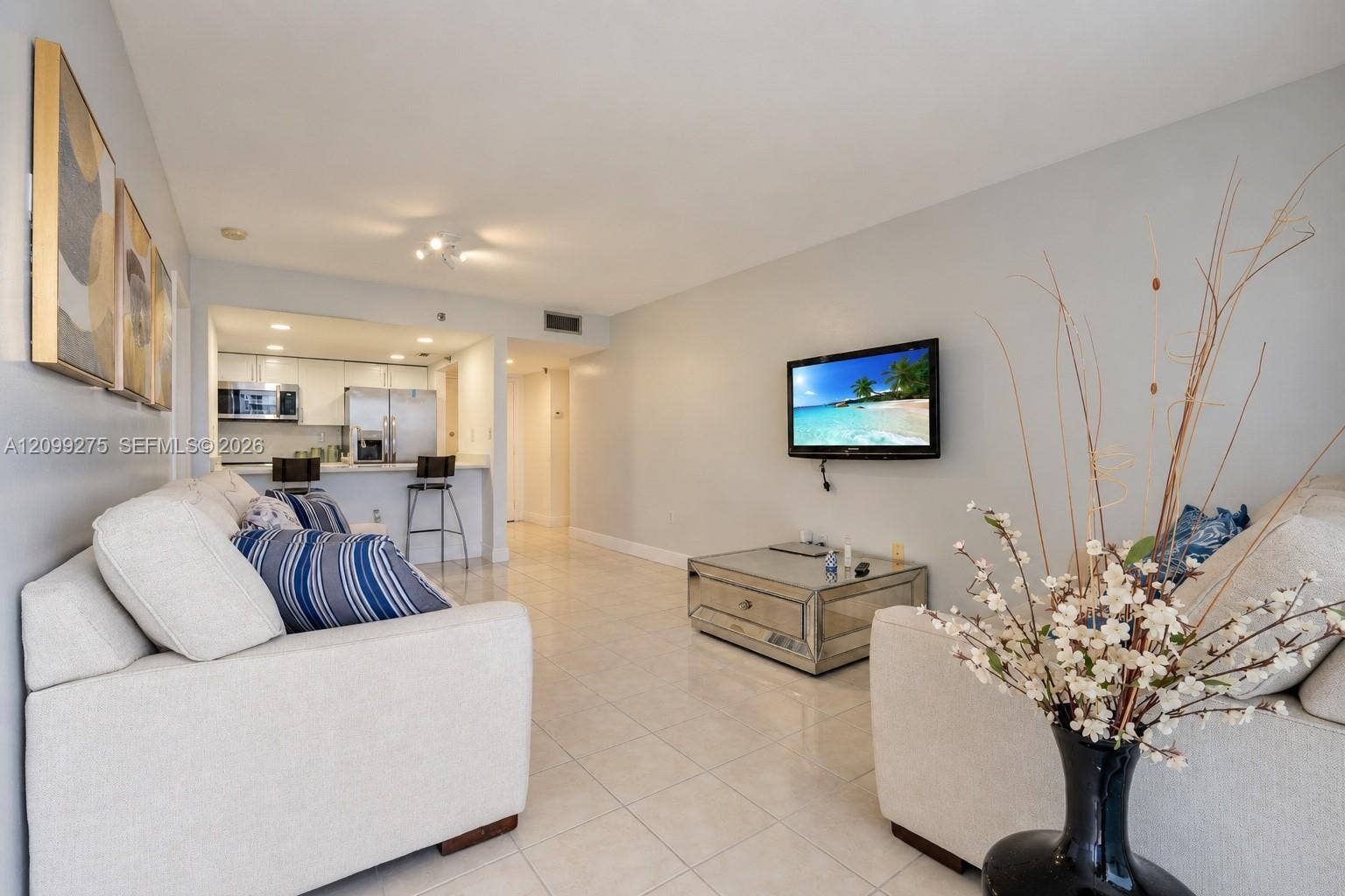 800 N Miami Avenue, #E-902, Miami, Miami, FL 33136 Spacious open-concept living area with elegant tile flooring, and a seamless flow into the kitchen with stainless steel appliances.