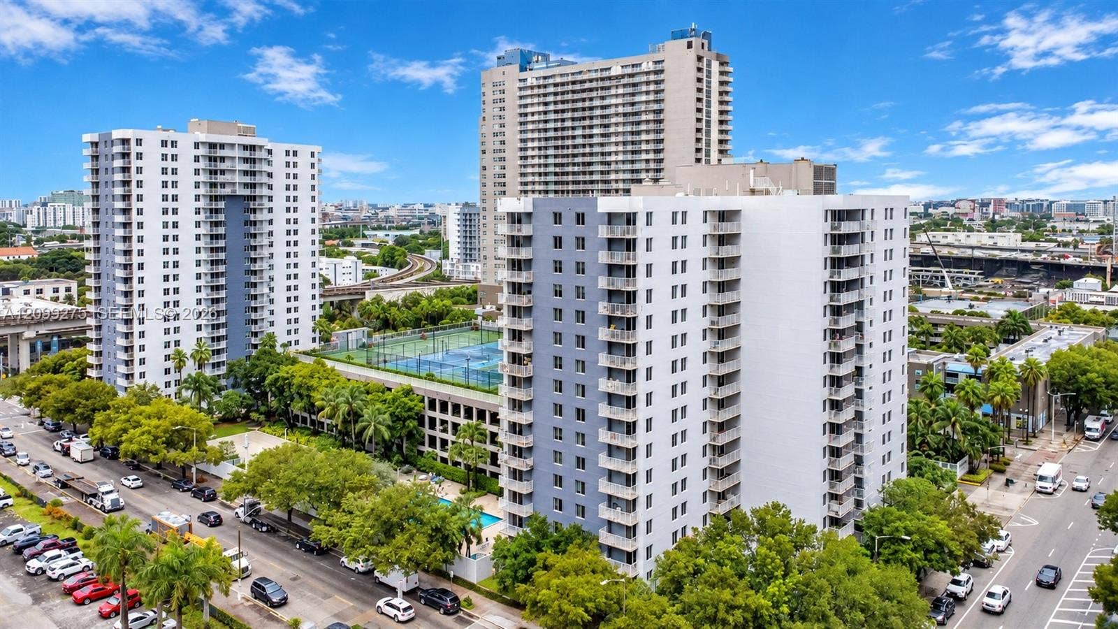 800 N Miami Avenue, #E-902, Miami, Miami, FL 33136 Aerial view of The Madison condominium community, showcasing modern high-rise buildings, lush tropical landscaping, and convenient urban surroundings.