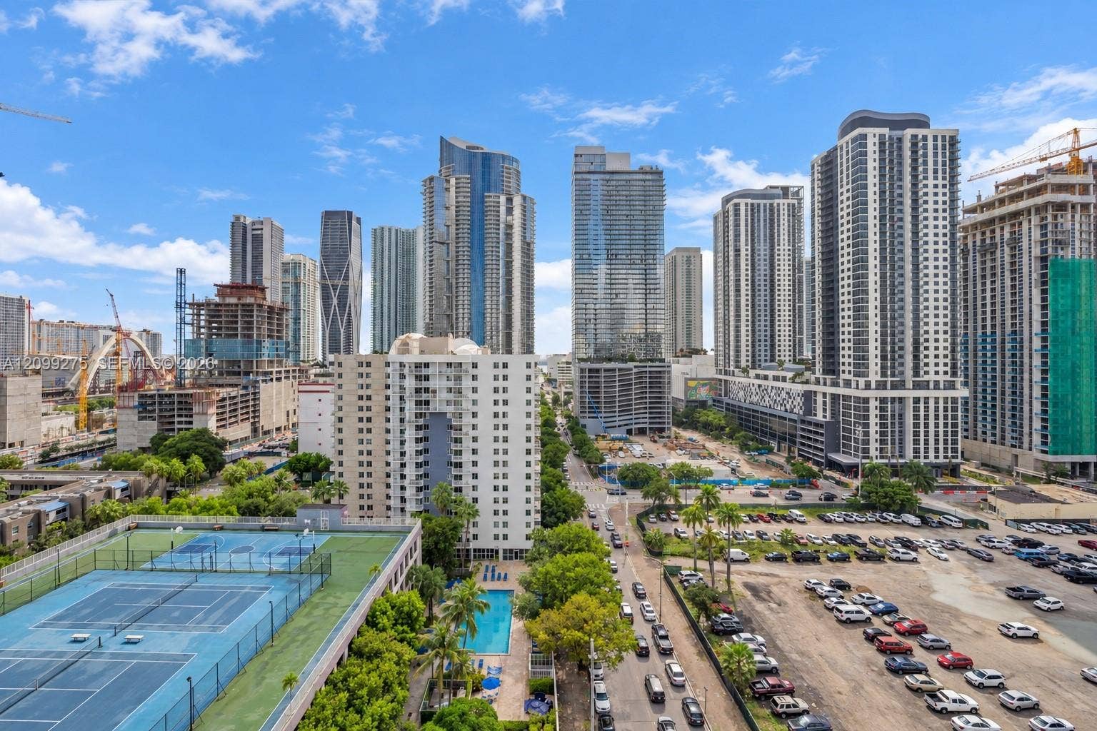 800 N Miami Avenue, #E-902, Miami, Miami, FL 33136 Panoramic city skyline showcasing modern high-rise buildings, with views of the community pool, sports courts, and vibrant urban surroundings.