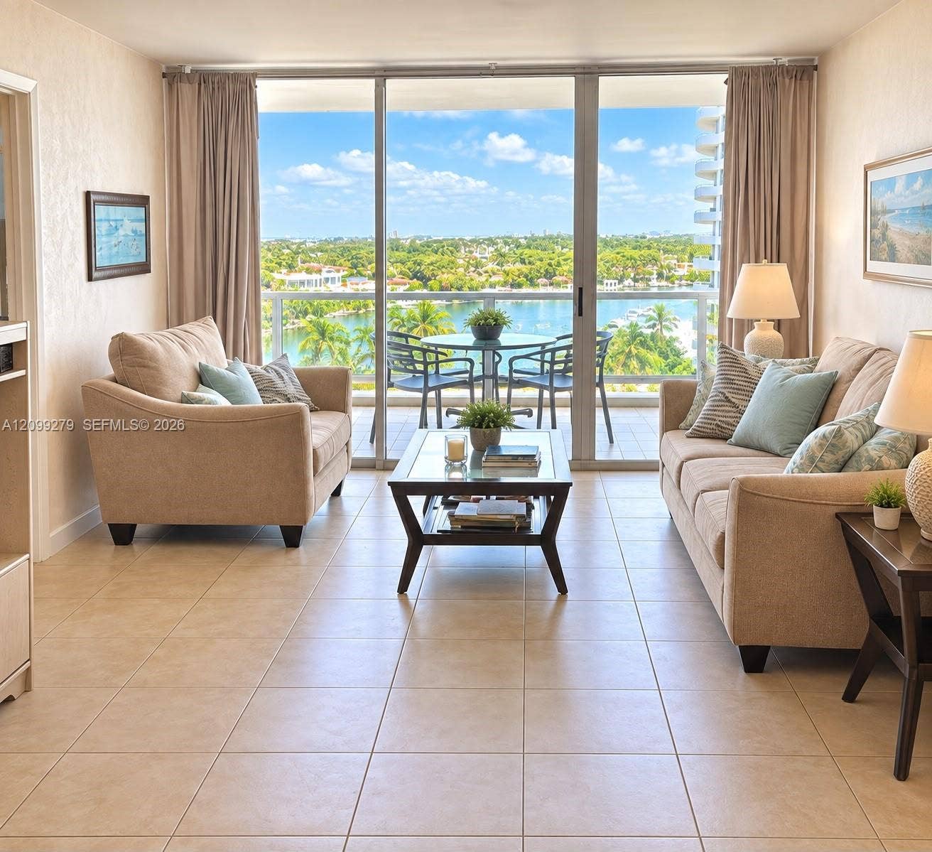 5151 Collins Avenue, #921, Miami Beach, Miami Beach, FL 33140 Full-height glass sliding doors, ceramic tile flooring, and a private balcony featuring a metal railing with a water backdrop