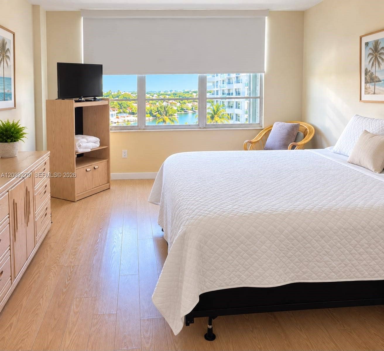 5151 Collins Avenue, #921, Miami Beach, Miami Beach, FL 33140 Large window featuring expansive water and landscape scenery, neutral wall tones, and wood-finish flooring