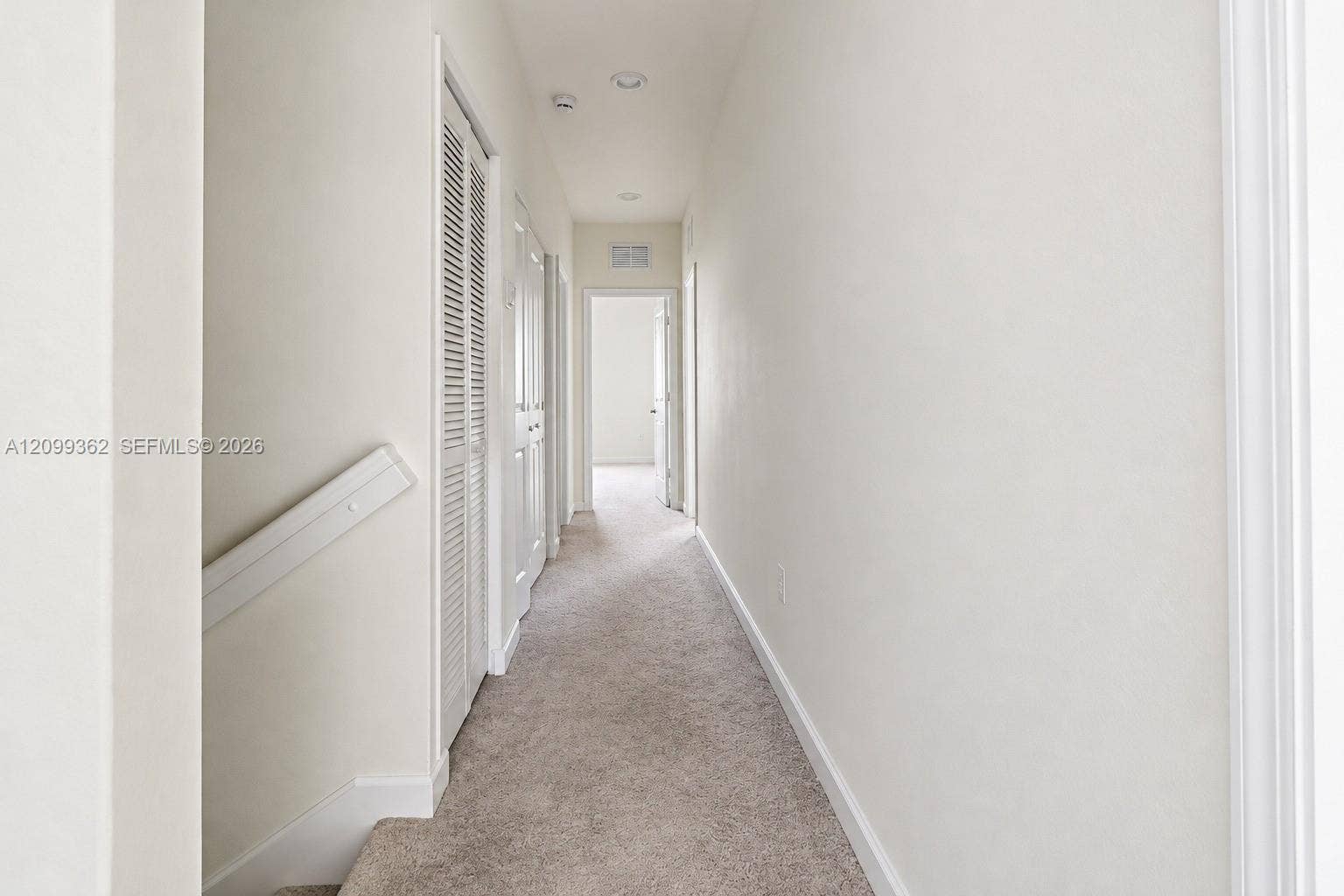 16230 SW 290th Terrace, Homestead, FL 33033 Hallway featuring neutral-toned carpeting, louvered closet doors, and recessed ceiling lighting